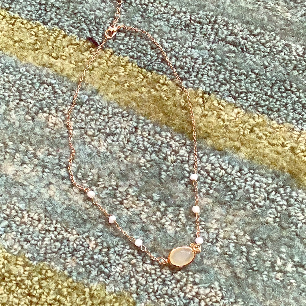 Gold necklace with pearls and green gem